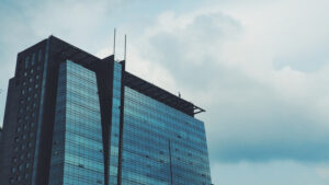 building with windows reflecting off clouds skyscraper