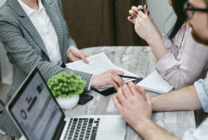 People at table with computer insurance services