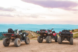 ATVs off road on mountain overlooking view